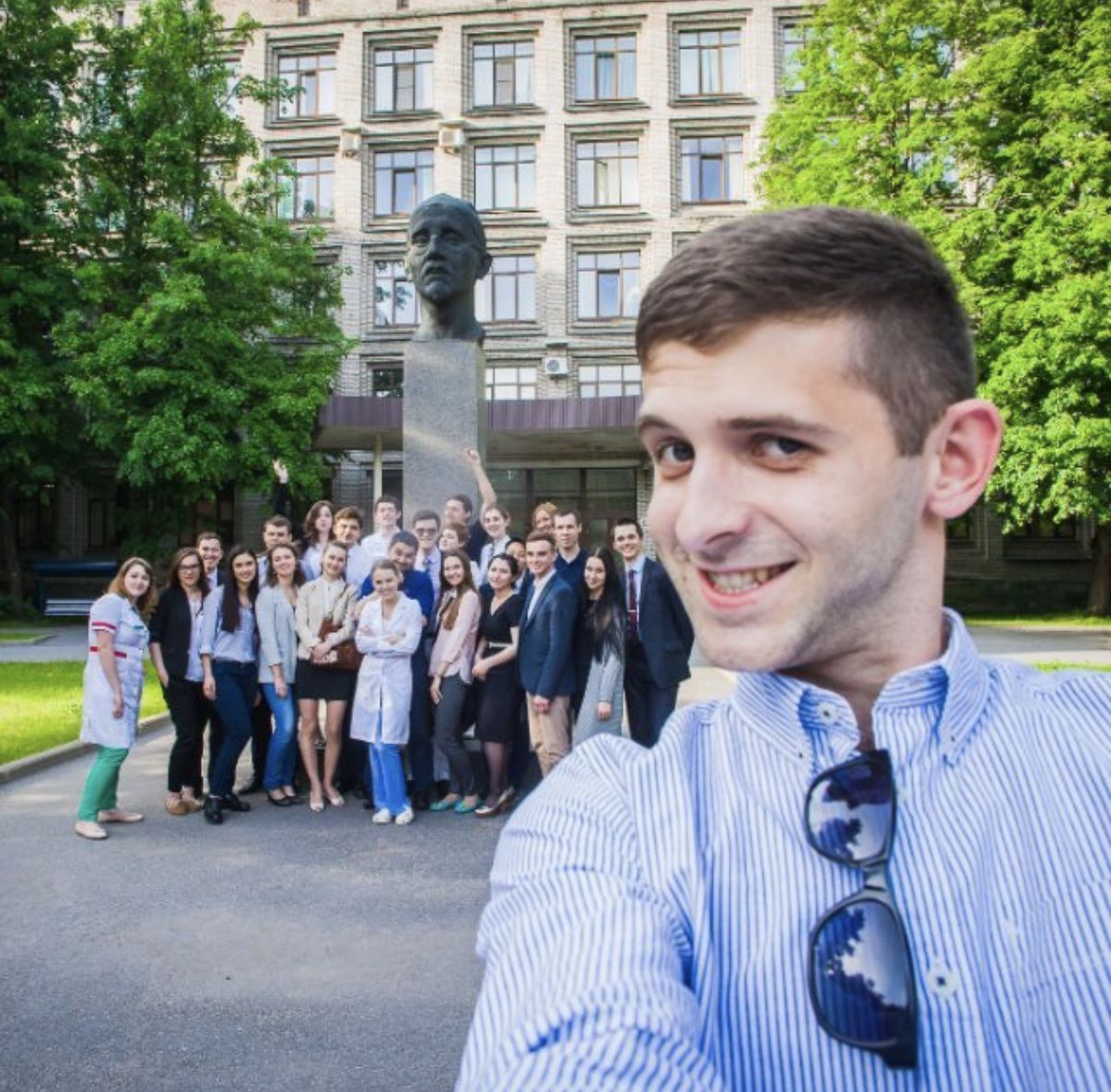 Alex taking a selfie in front of the second intake of the programme, a large group of young doctors gathered at the bust in front of the N.N. Petrov Research Institute of Oncology.